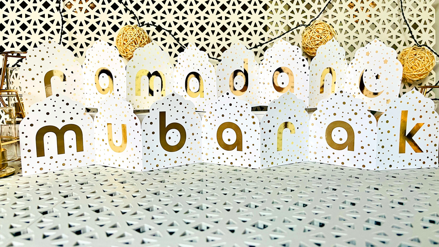 Decorative banner with 'ramadan mubarak' text on a textured surface.