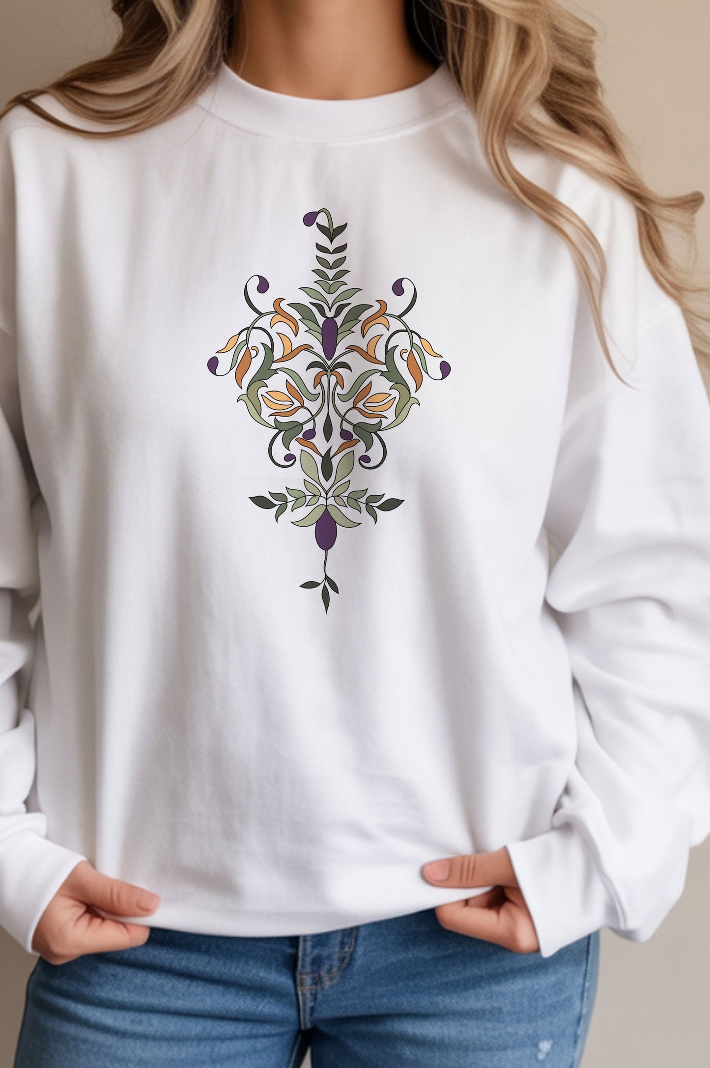 White sweatshirt with a decorative Olive branch design worn by a person, on a plain background 